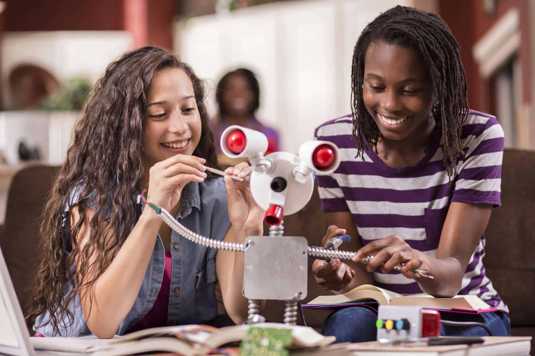 Girls learning about engineering, science, robotics, STEMM, and STEAM