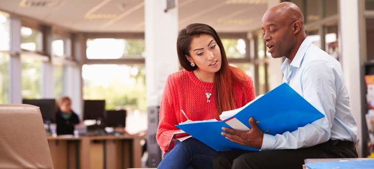 College Student Having Meeting With Tutor To Discuss Work